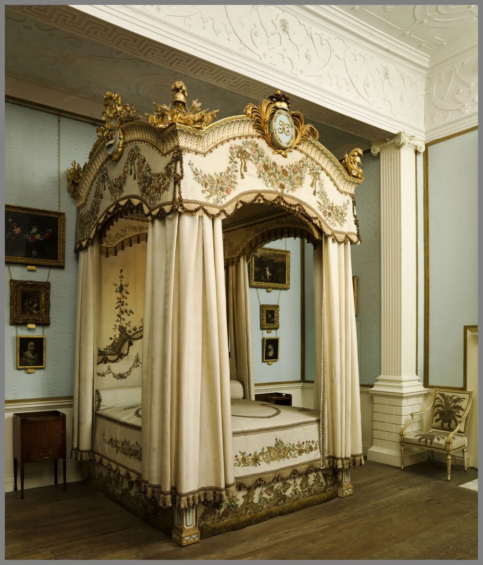The state bed with its cream and gold canopy