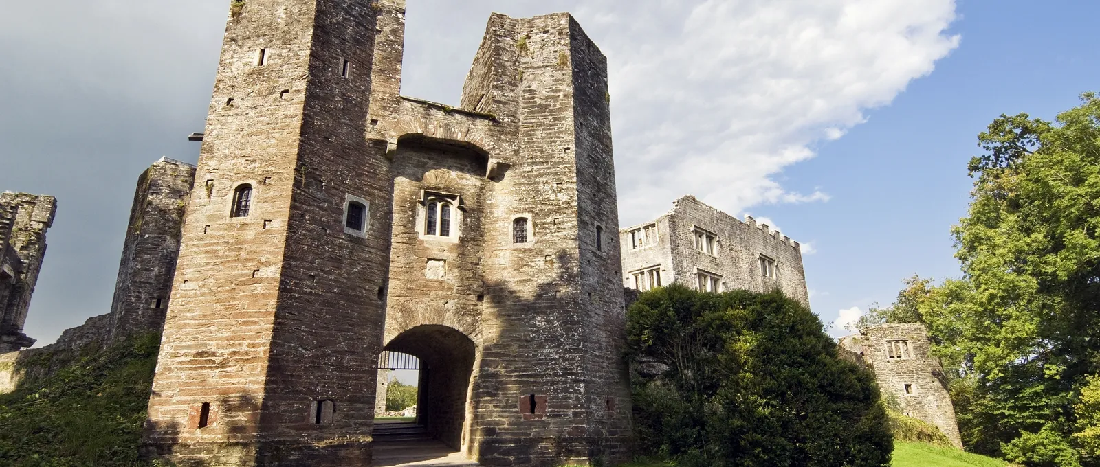 The twin towers of the gatehouse and the mansion beyond in afternoon sun