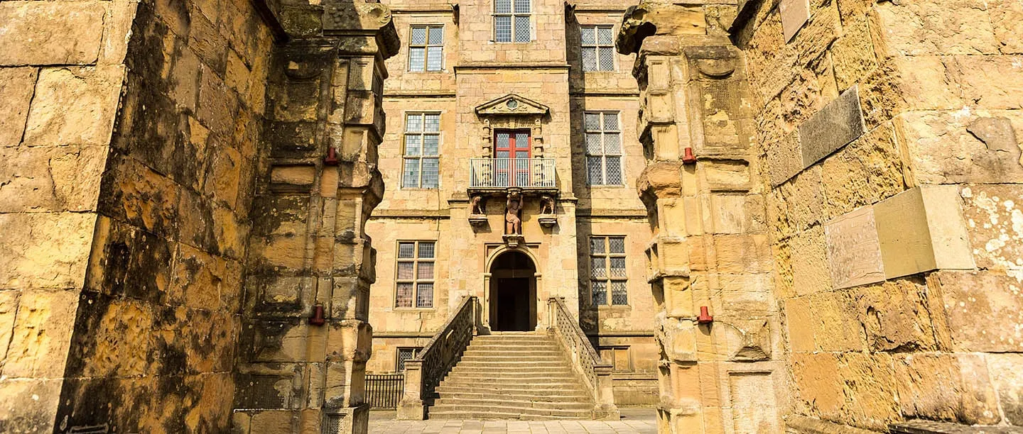 The Little Castle's entrance and steps between golden stone walls