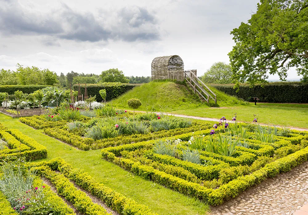 Box-hedged knot garden at Boscobel with the grass mound and its willow arbour