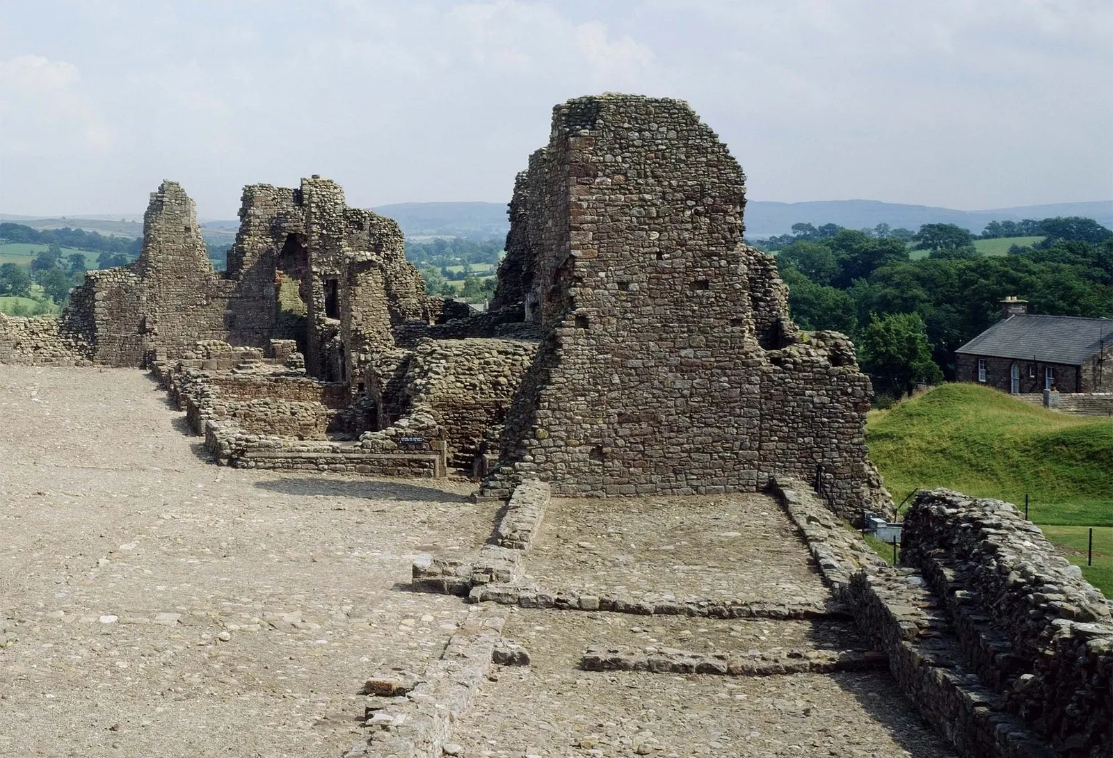 Inside Brough Castle: the cobbled courtyard and the ruined walls of the hall range