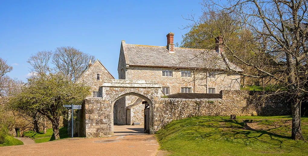 The gate arch and stone house by the bowling green in spring sunshine