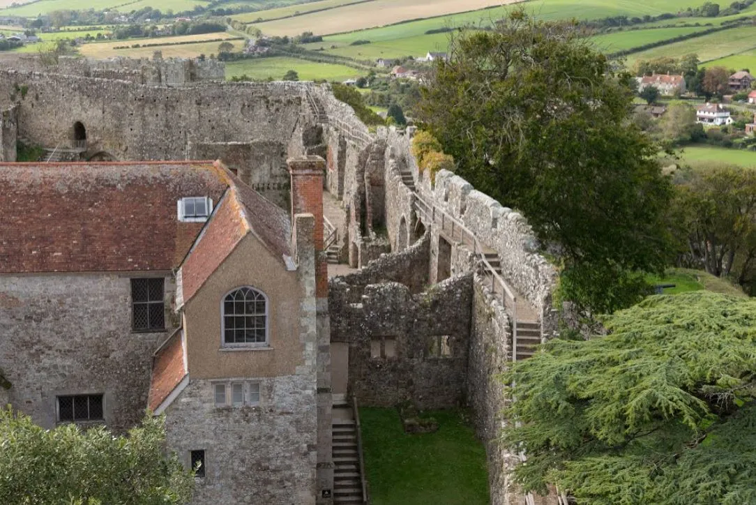Tiled roofs and the curtain wall walkway above green Isle of Wight farmland