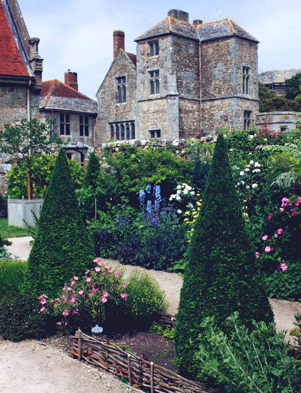 Topiary cones and rose borders in the walled garden below the castle buildings