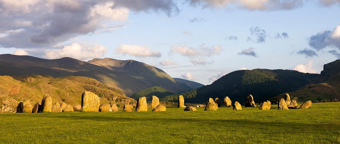 The stone circle glowing in evening sun below the fells