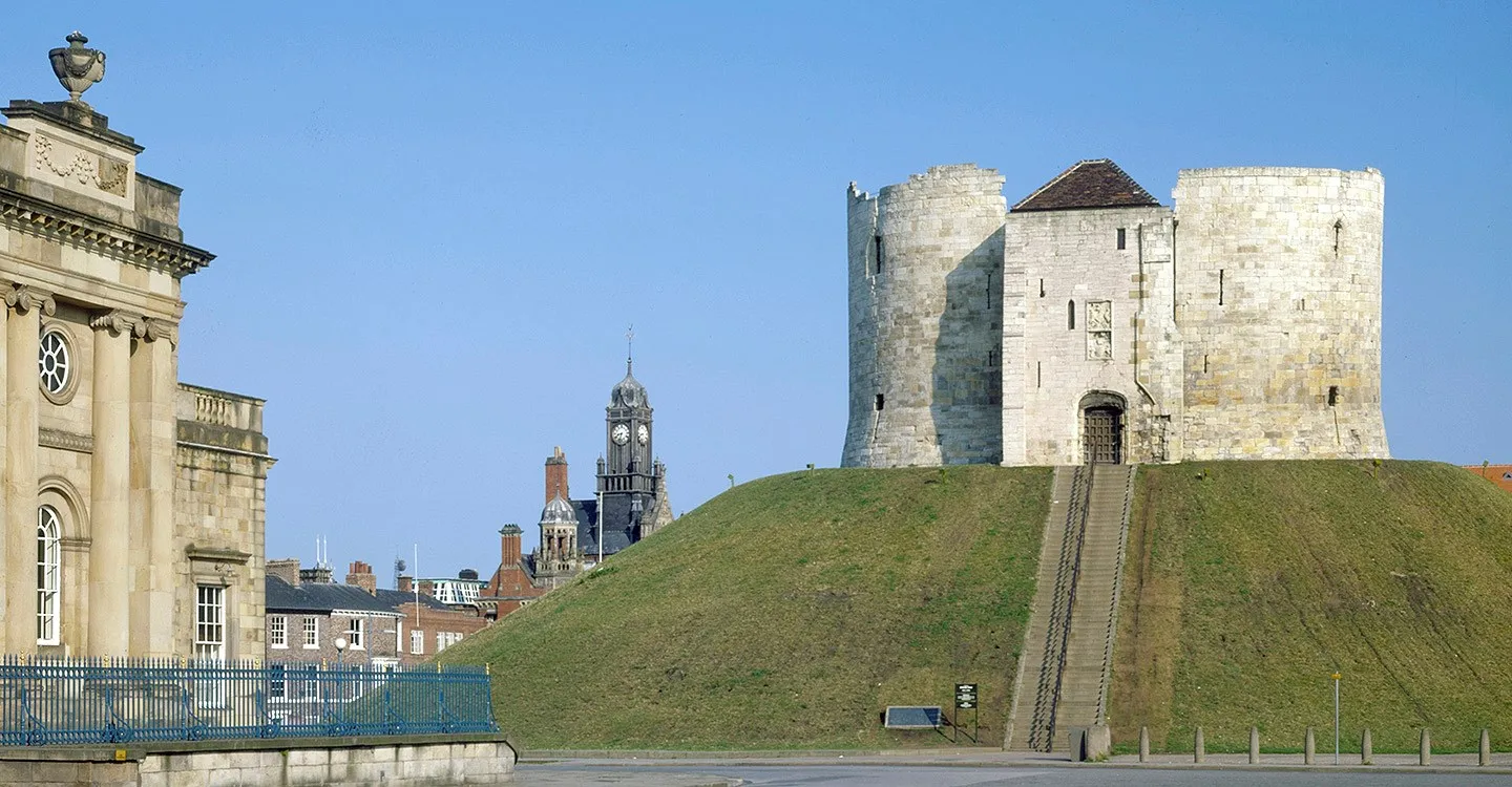 The tower and steps up the motte, beside a neighbouring classical building