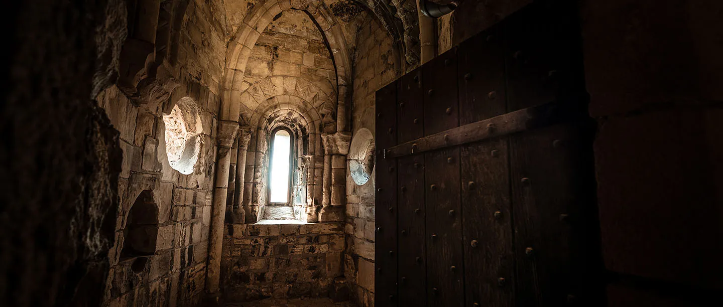 Light falling through a narrow window into the keep's carved chapel