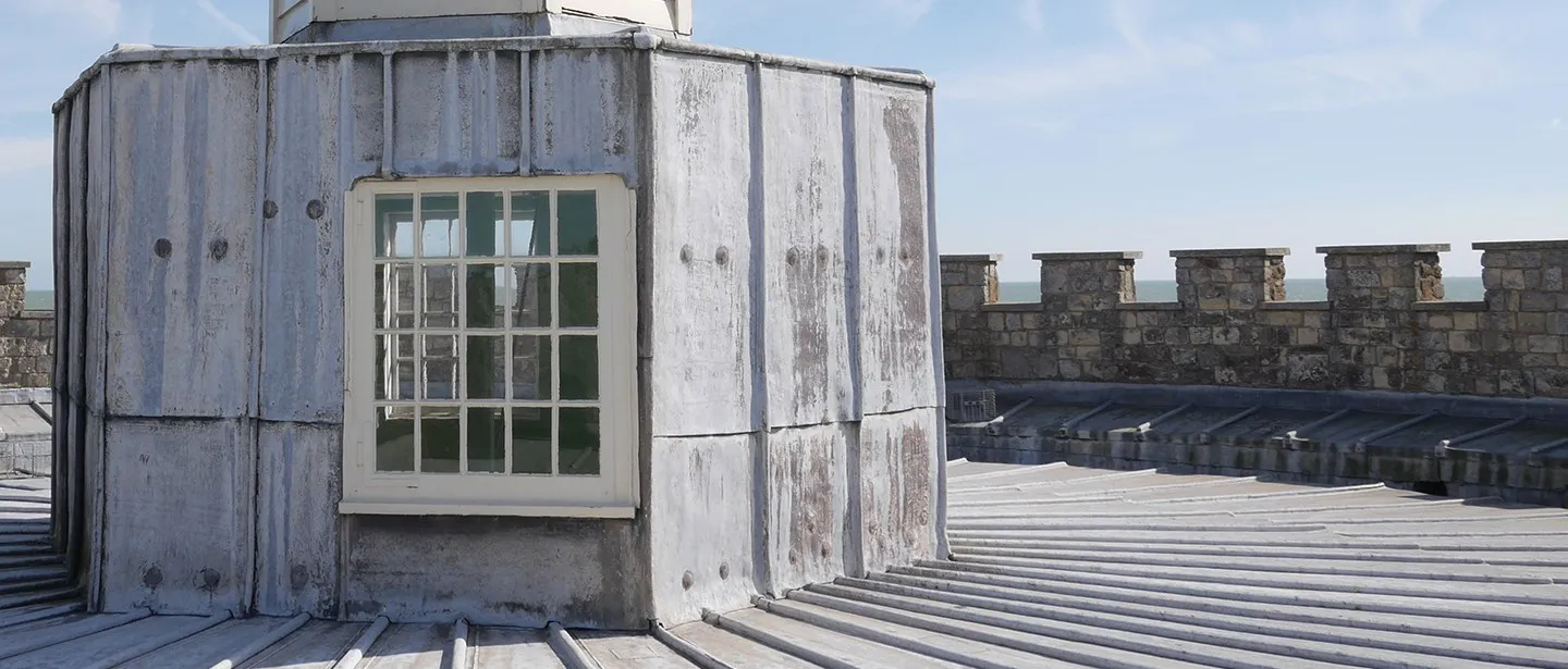 The white-painted lantern turret on the keep roof, with the battlements and sea beyond