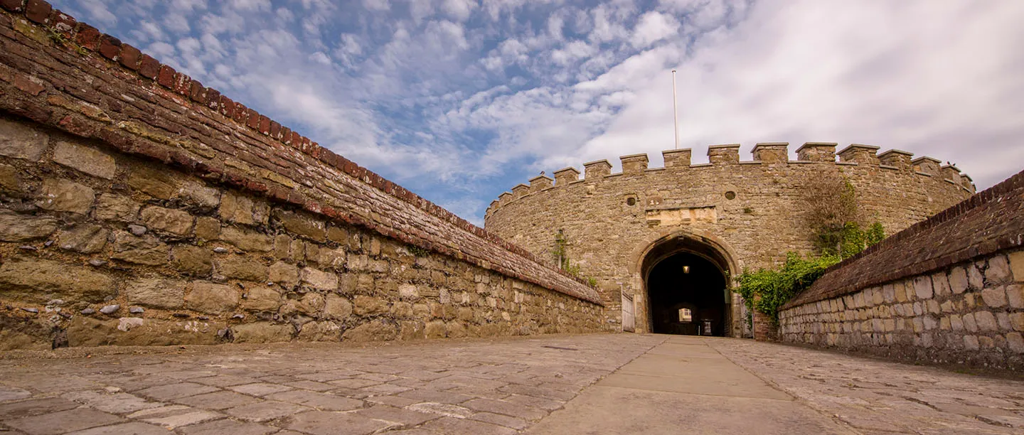 The gatehouse arch at the end of the walled entrance causeway
