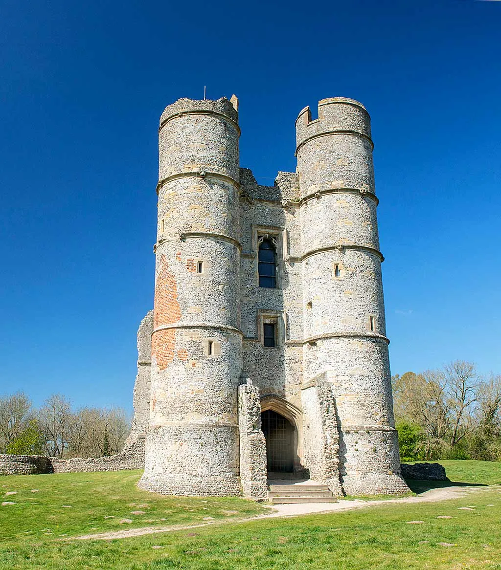 The twin drum towers of the gatehouse against a deep blue spring sky