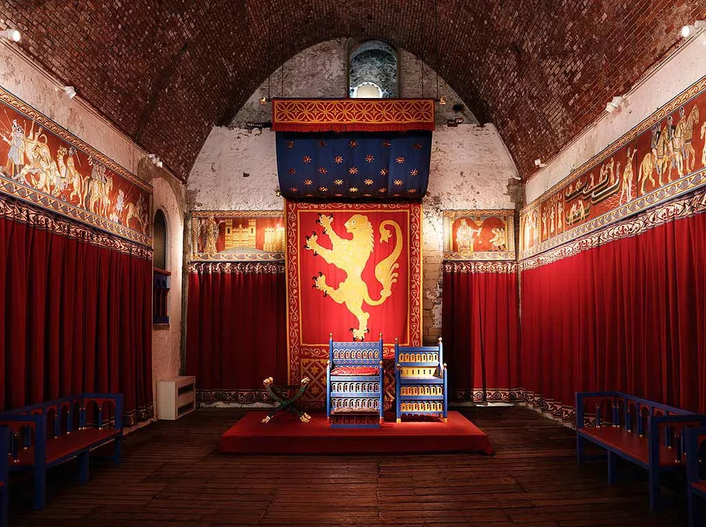 The great tower's hall, furnished with a throne and red hangings