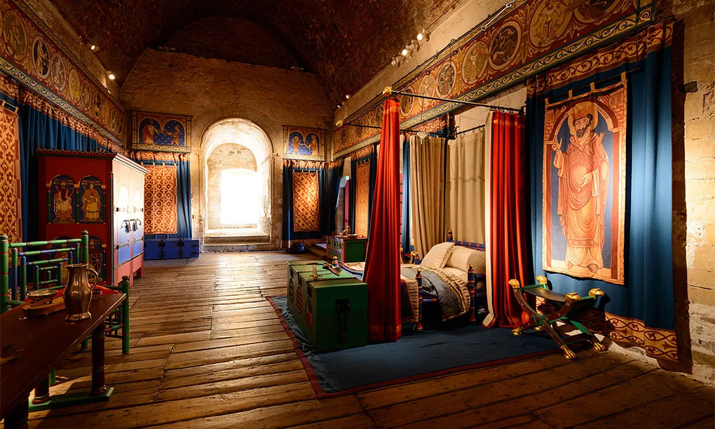 The king's chamber in the great tower, with a curtained bed and painted hangings