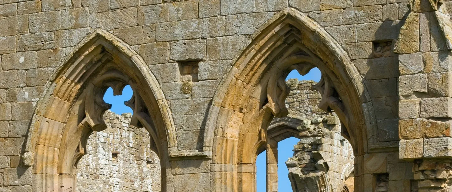 Two pointed windows with trefoil tracery in the sandstone walls of Egglestone Abbey