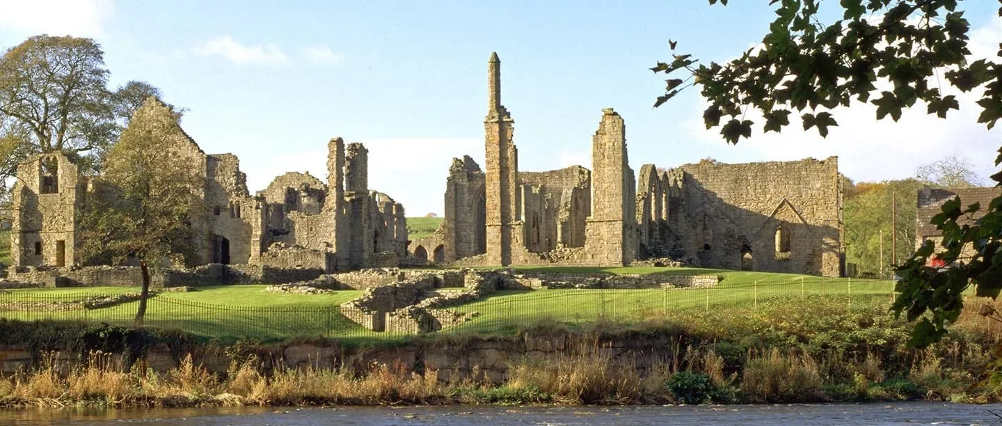 The ruins of Finchale Priory across the River Wear on a sunny autumn day