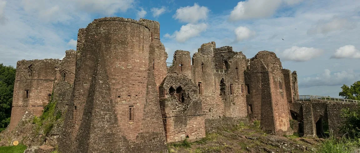 The great spurred towers and gatehouse bridge under a blue sky