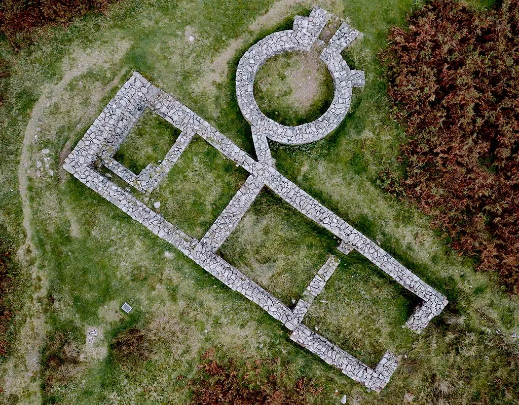 Vertical aerial view of the stone footings of the bath house outside Hardknott Roman fort, beside bracken