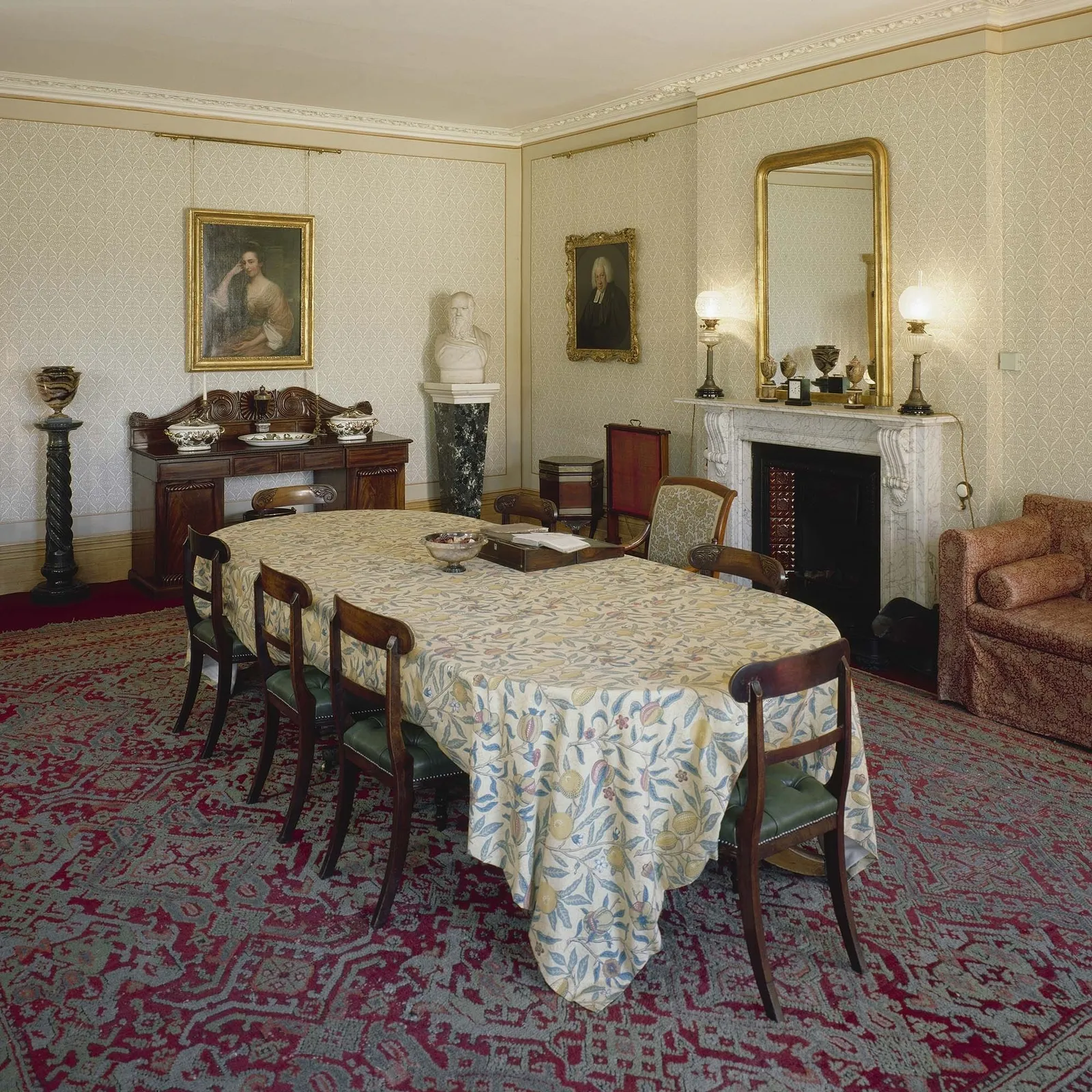 The dining room, with its patterned tablecloth, sideboard and marble bust of Darwin