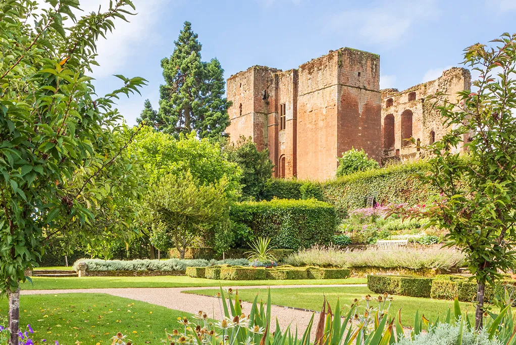 The keep rising above the Tudor garden's hedges and borders