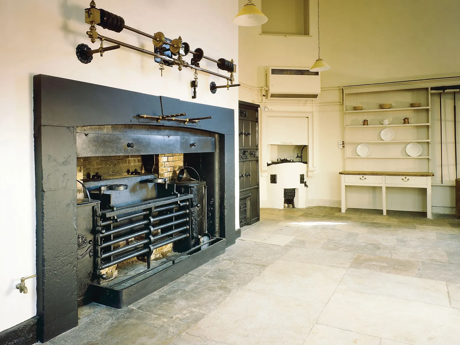 The great iron range and roasting spit in the kitchen