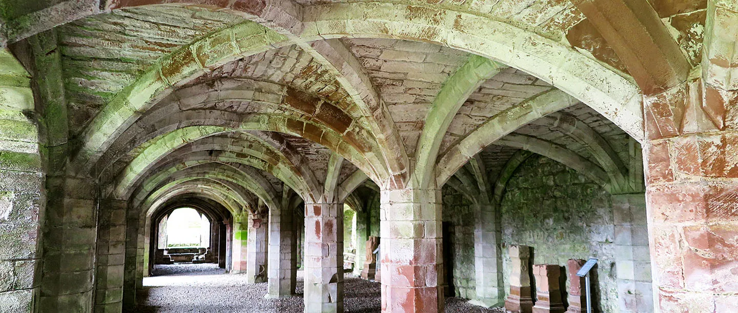 The vaulted undercroft beneath the refectory, its ribs stained green and pink