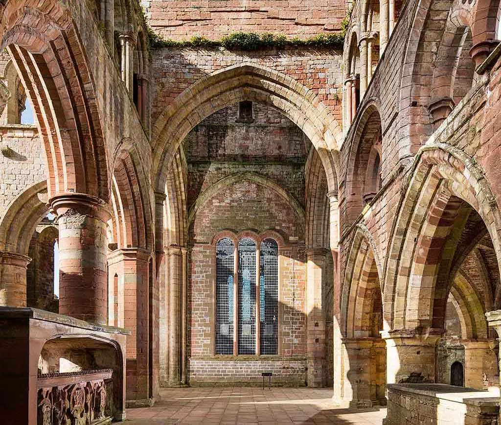 Tall pointed arches and the east end inside the roofless priory church