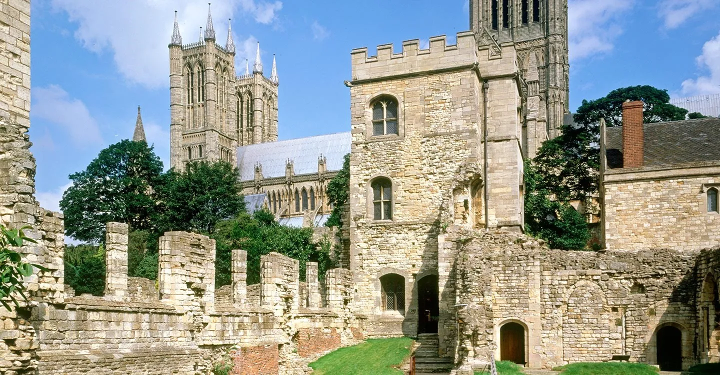 The Alnwick Tower and ruined walls of Lincoln Medieval Bishops' Palace with the cathedral towers behind