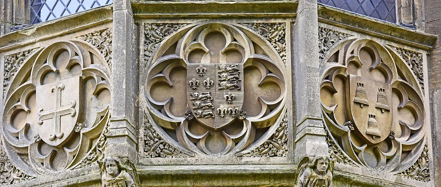 Carved quatrefoils with heraldic shields and angels below the oriel window of the Alnwick Tower