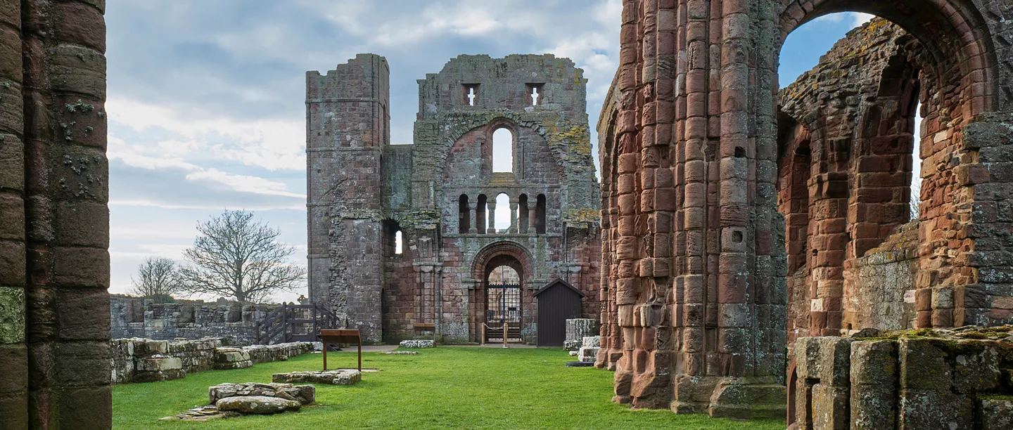 Inside the ruined priory church, looking past a carved pier to the west towers