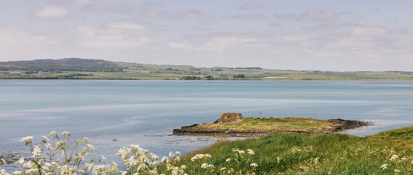 St Cuthbert's Isle and its wooden cross across the water at high tide