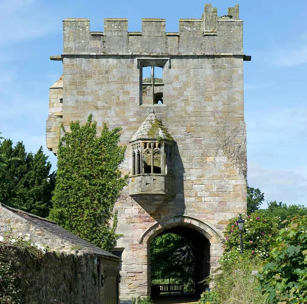 The battlemented gatehouse of Marmion Tower with its stone oriel window above the entrance arch