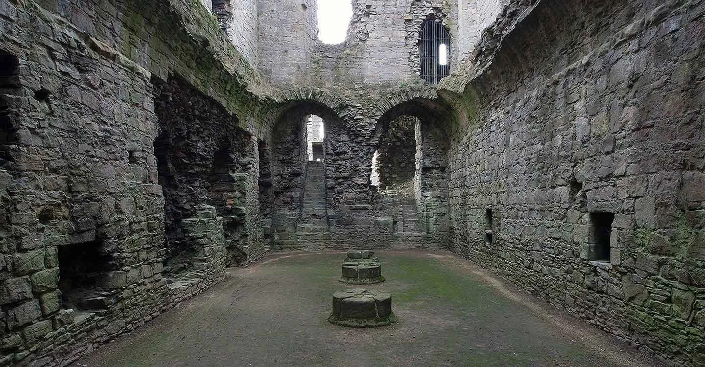 Inside the keep's vaulted basement, with arched recesses and a stair