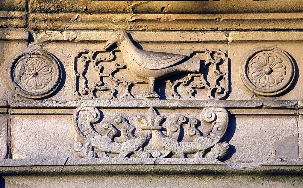 Carved stone frieze on Moreton Corbet's south range with a raven between rosettes and scrollwork