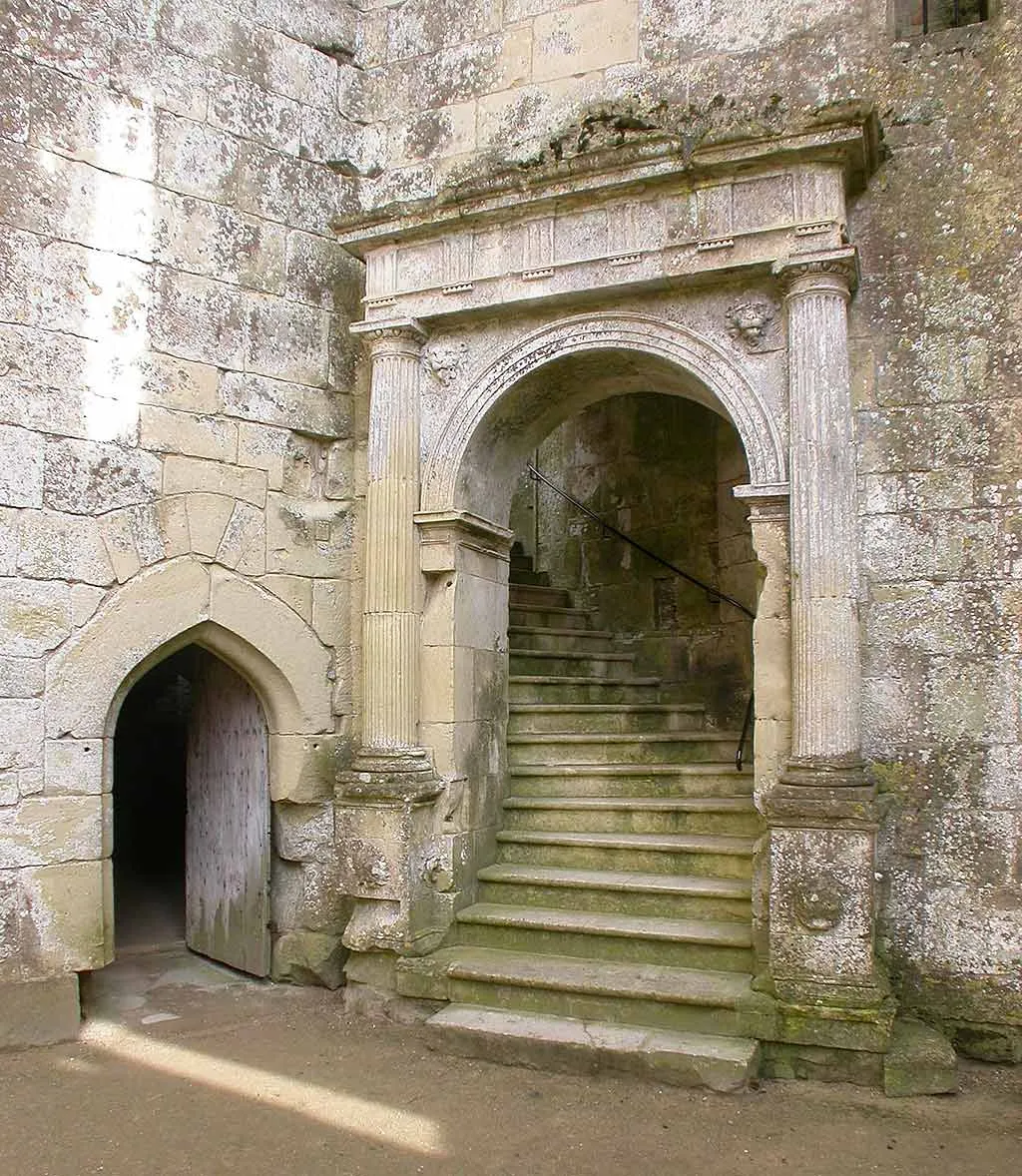 The Renaissance arched entrance to the great hall, with a stone stair rising inside