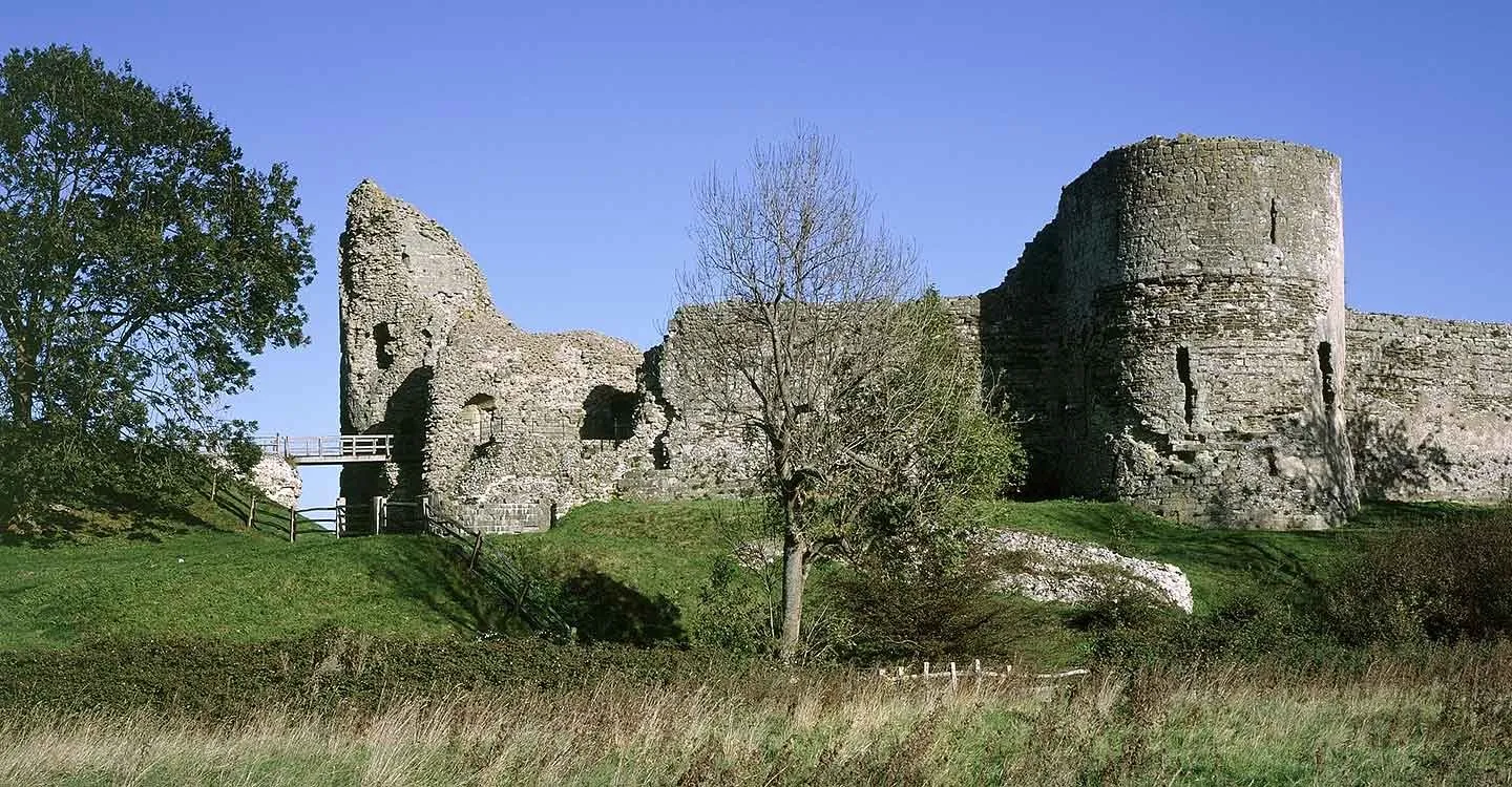 The ruined keep and a round tower of the inner bailey under a clear blue sky