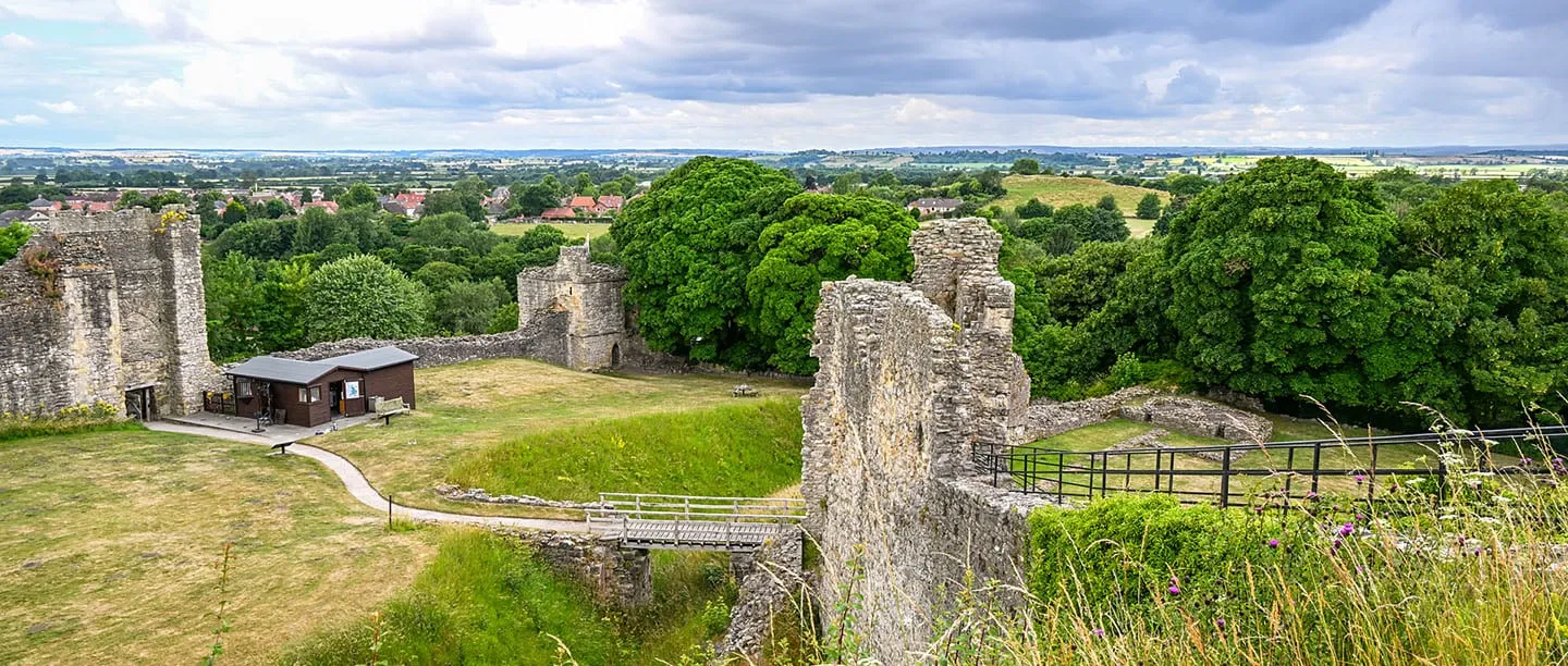 The inner ward of Pickering Castle from the motte, with the gatehouse, curtain wall and the town beyond