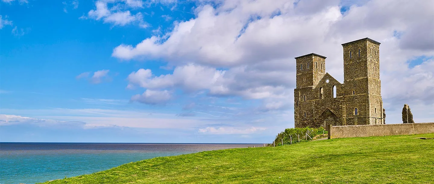 The twin towers of the ruined church on their grassy headland above the sea
