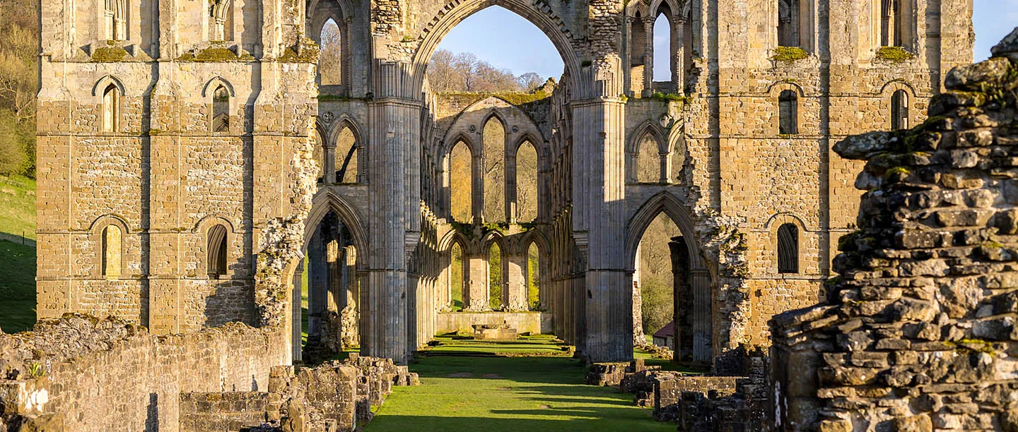 The transept and nave arcade lit gold by low sun