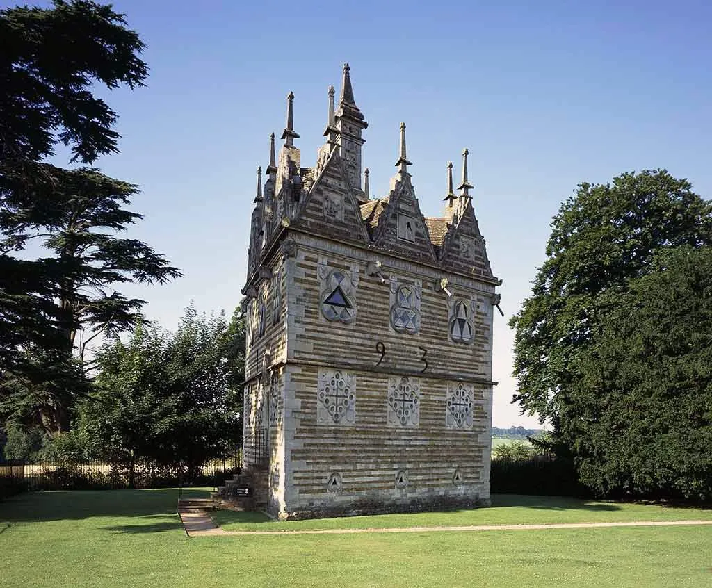 The north front of Rushton Triangular Lodge with trefoil windows, carved panels and the numbers 9 and 3