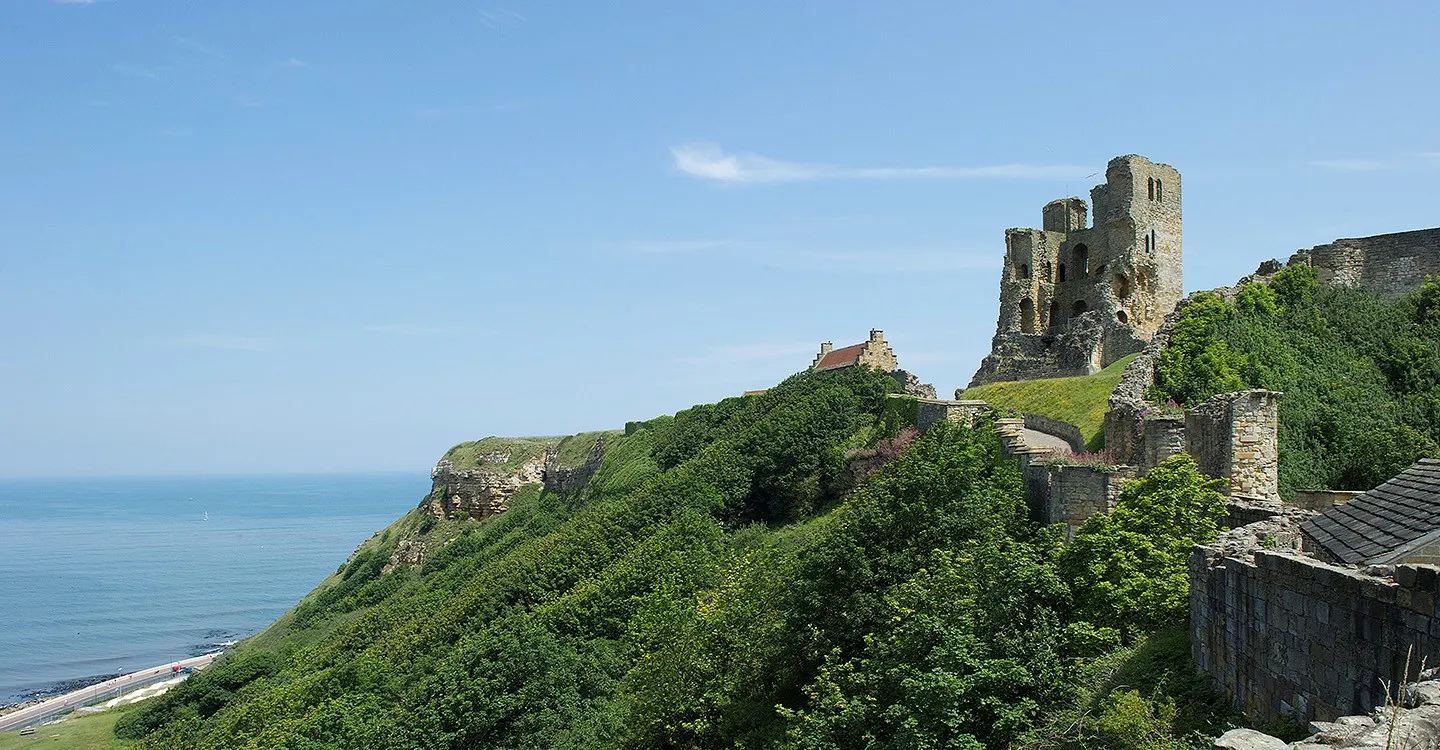 The castle ruins on the headland above the sea and the North Bay