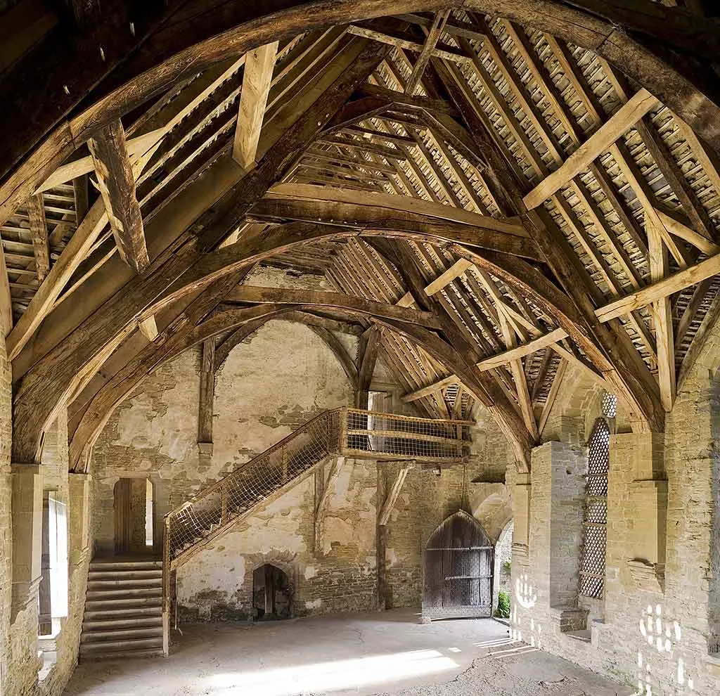 The great hall's cruck roof timbers and its original wooden staircase