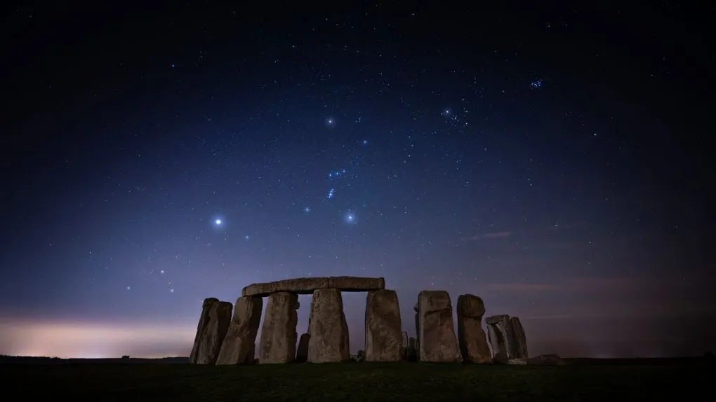 Stonehenge under a night sky full of stars