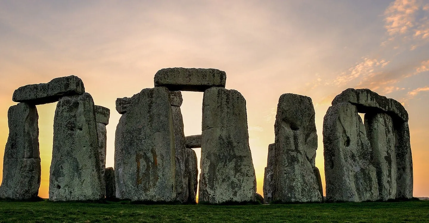 The stones silhouetted against a pink sky