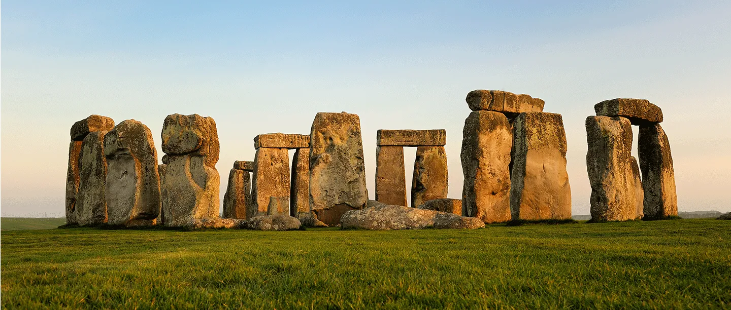 Stonehenge lit gold by low sun