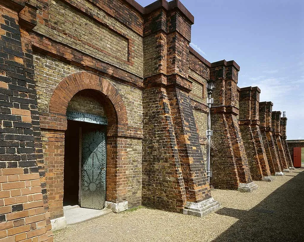 The buttressed brick gunpowder magazine with its studded iron door