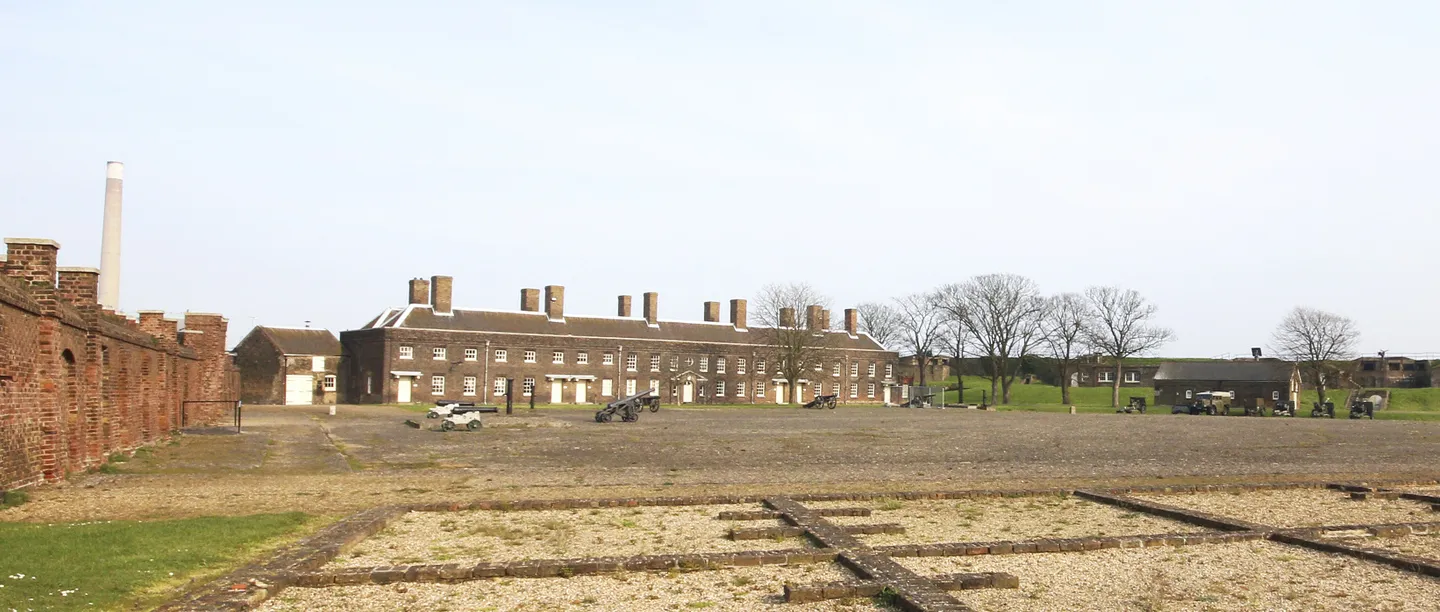The parade ground with cannon in front of the brick officers' barracks and the casemated walls