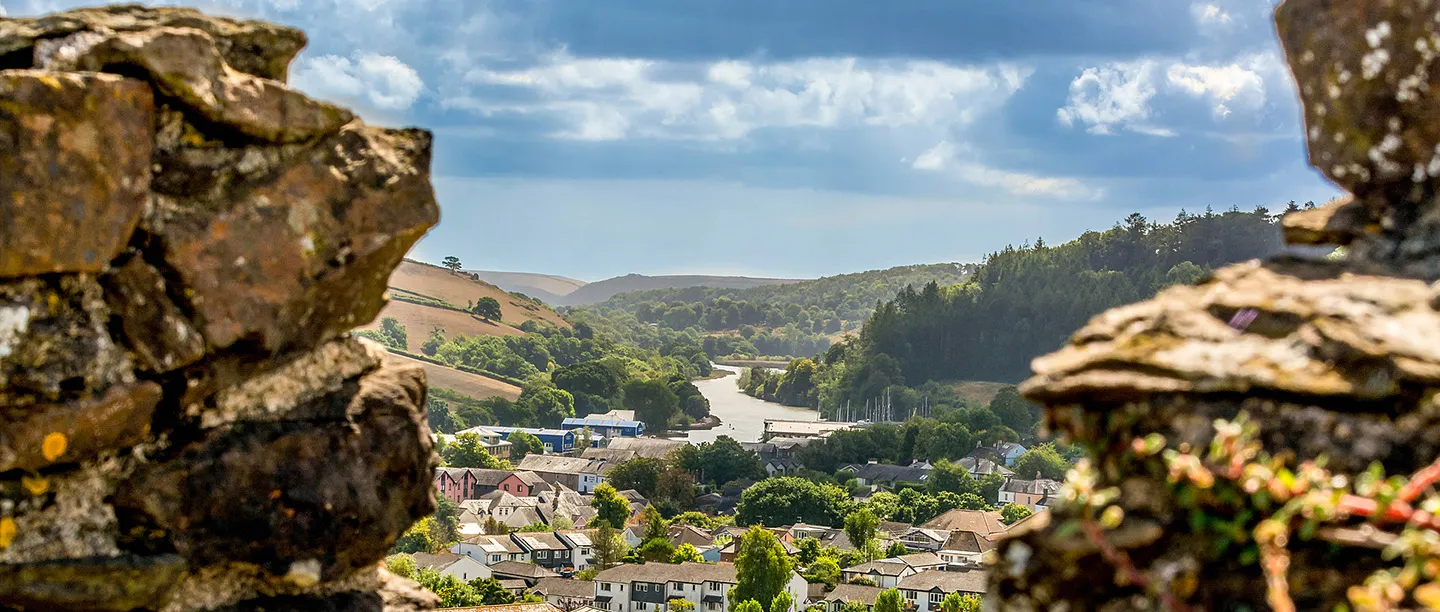 The view from the keep's battlements down the wooded Dart valley over the town