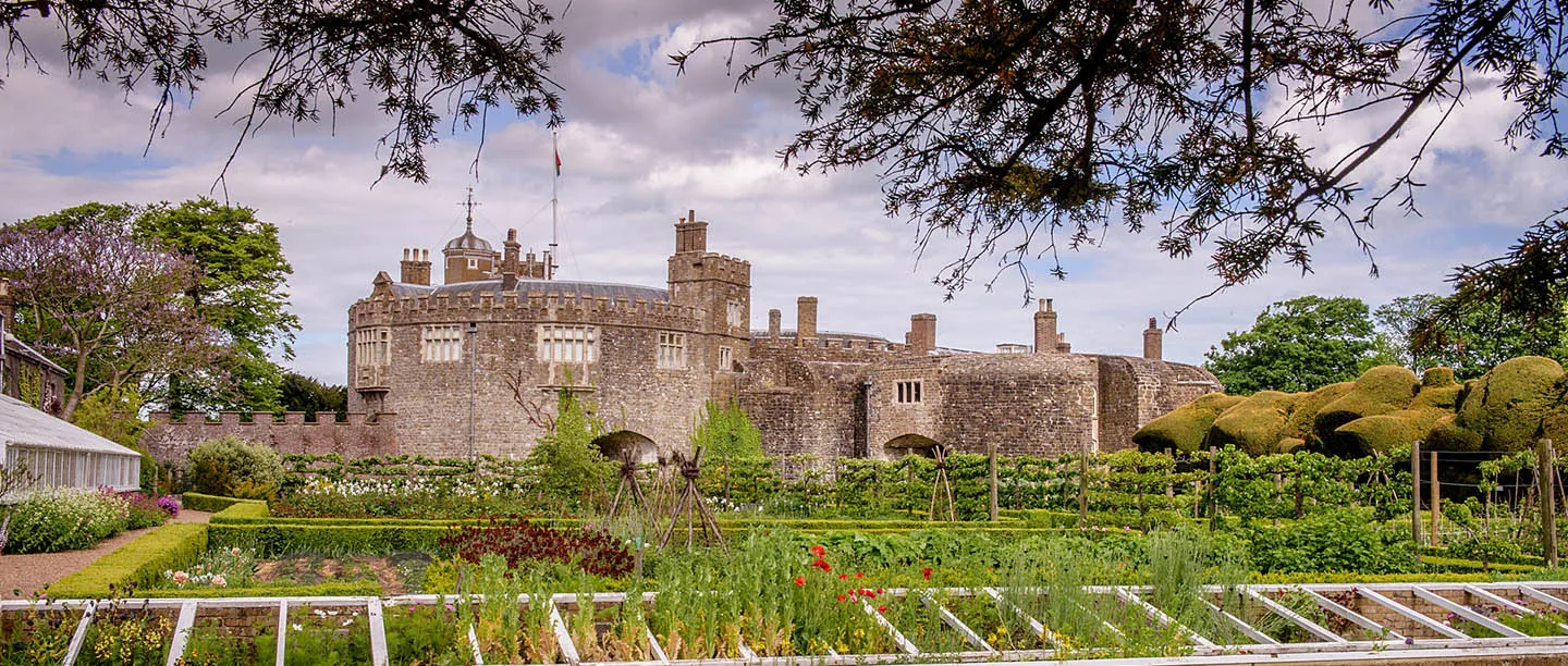 The round bastions and battlements of the castle beyond the kitchen garden