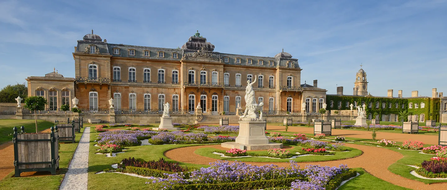 The parterre's flower beds and statues below the garden front of the house