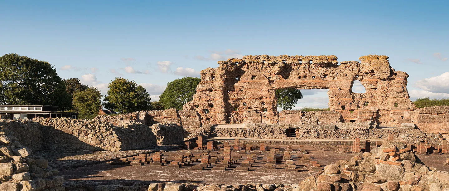 The Old Work, a towering fragment of Roman masonry, above the hypocaust pillars of the bath house